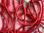 Detail of red tubing on painting 2023